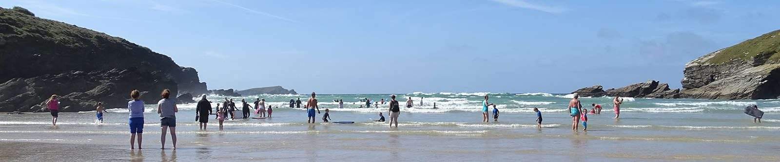 People paddling in the sea at Porth