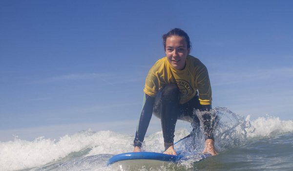 girl kneeling on a surf board