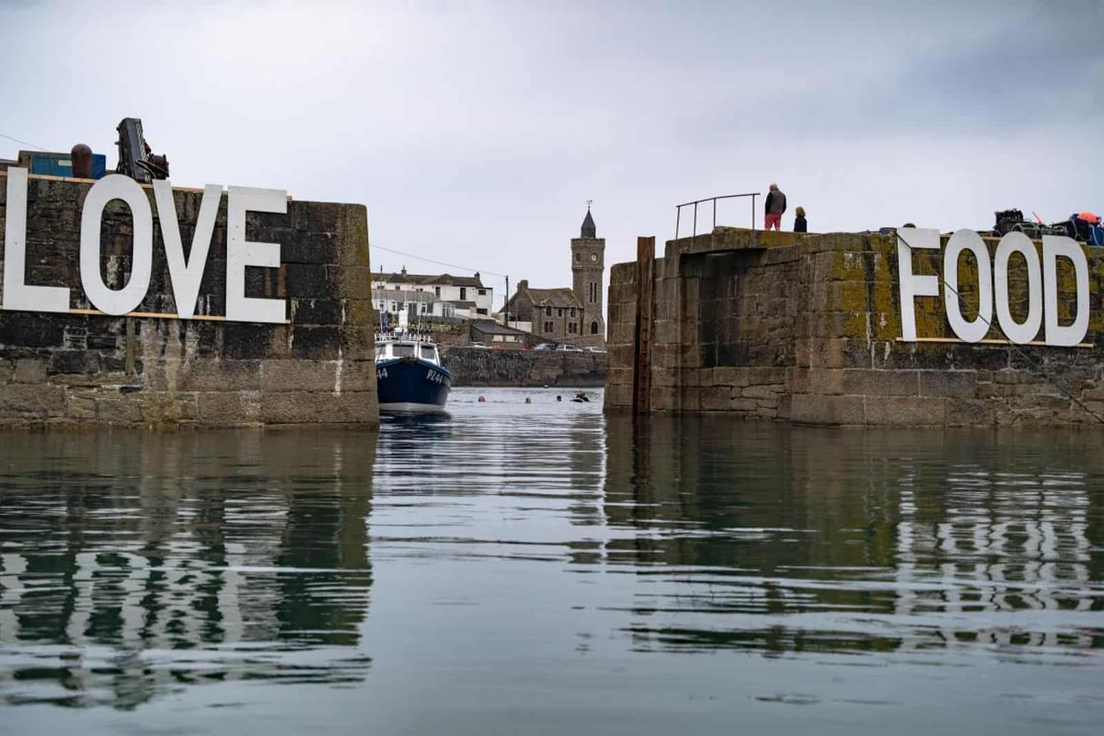 Porthleven Harbour with Love Food sign